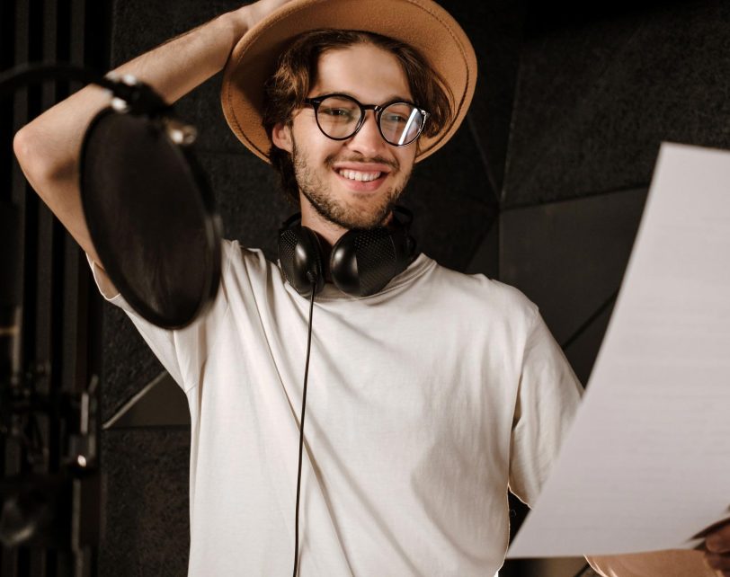 portrait-of-young-smiling-male-singer-happily-read-XWDM9AM