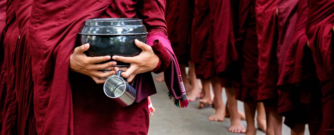 detail-of-buddhist-monks-crowd-and-person-holding-PKCY67V