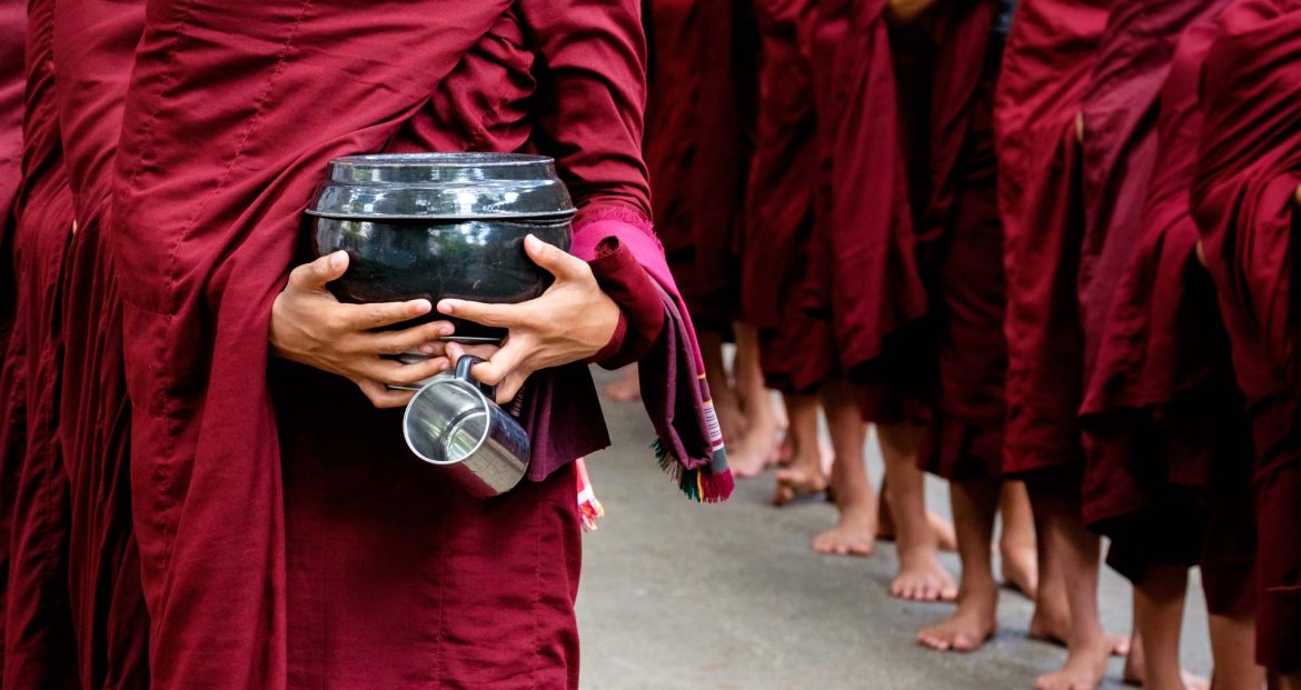 detail-of-buddhist-monks-crowd-and-person-holding-PKCY67V