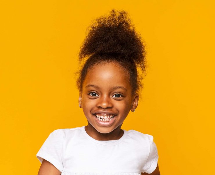 portrait-of-african-little-girl-smiling-over-GXAWB8R
