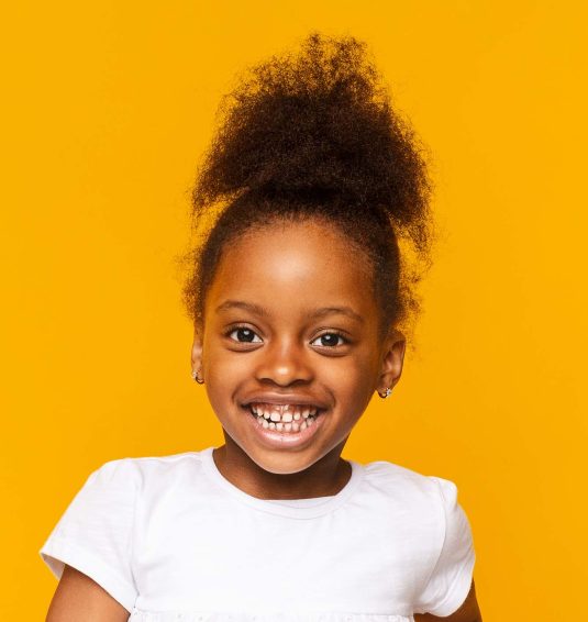 portrait-of-african-little-girl-smiling-over-GXAWB8R
