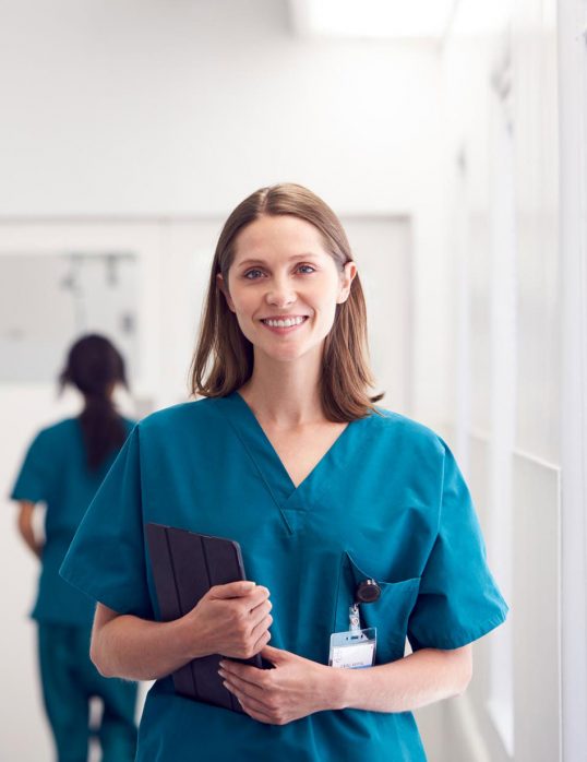 portrait-of-smiling-female-doctor-wearing-scrubs-HZ79GZQ-1