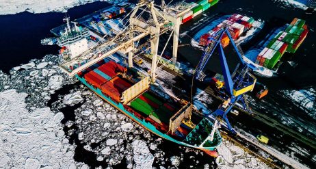 Industrial port with containers in winter, vessel loading in port of Finland