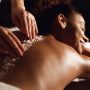 African-american woman having exfoliation treatment in spa salon