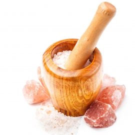Himalayan pink salt in wooden mortar