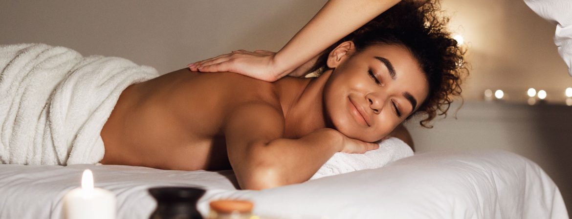 Beauty treatment. Masseur doing massage on woman body in spa center