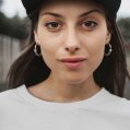 Hipster teen girl posing over urban background. Street swag style, cap, natural long hair, beauty model face