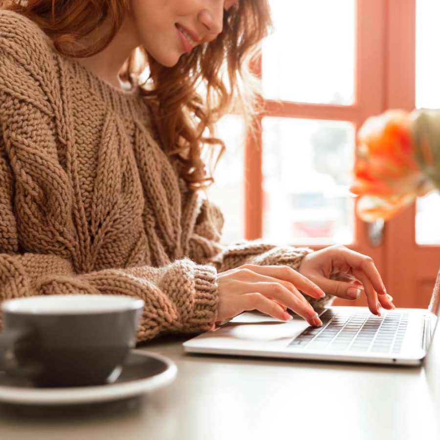 close-up-of-a-smiling-young-woman-working-AD9748H